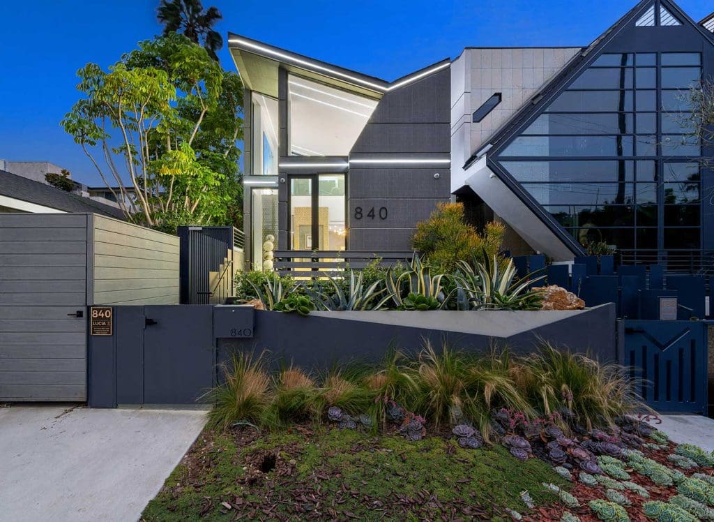 New house with numerous windows and lush green gardens