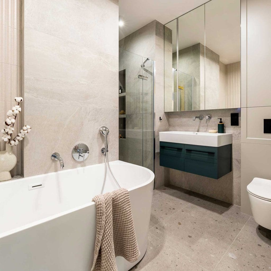 Wash basin with dark cabinet and bathtub, plumbing in Townsville
